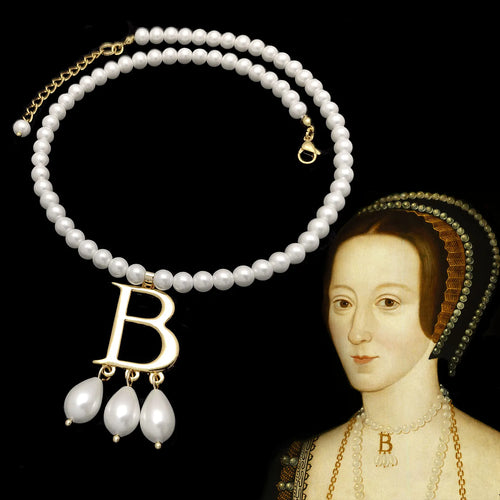 Anne Boleyn B pearl necklace displayed next to a portrait of Queen Anne Boleyn