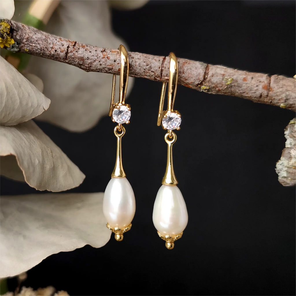 Close up Alexandrine Earrings hanging on a tree branch