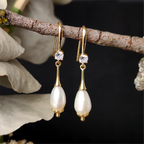 Close up Alexandrine Earrings hanging on a tree branch