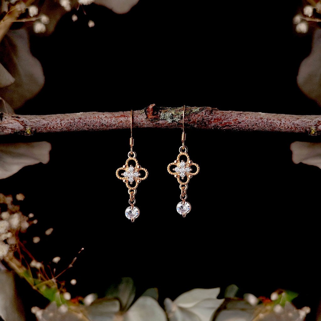 Georgian style crystal drop earrings styled on a branch with floral background