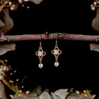 Georgian style crystal drop earrings styled on a branch with floral background