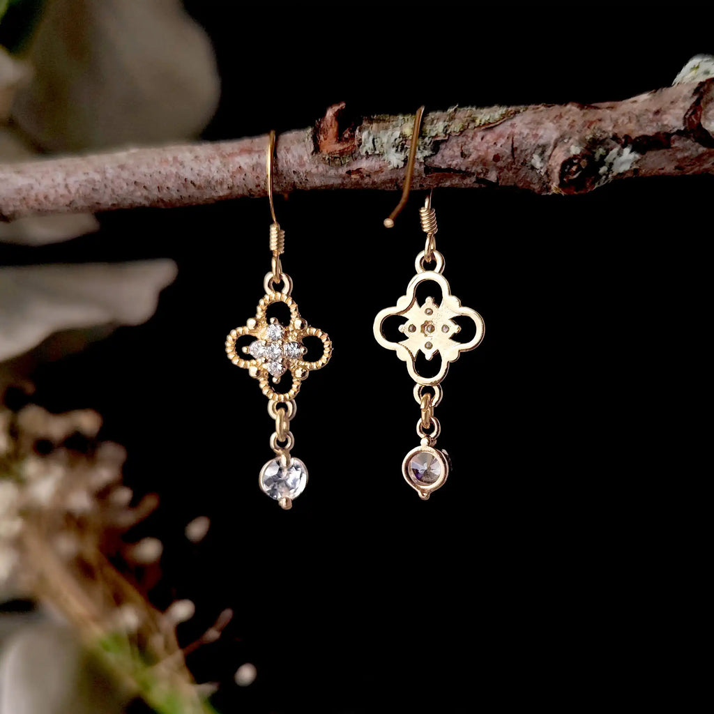 Georgian style crystal drop earrings styled on a branch with floral background