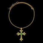 Total Upper view of a gold plated rolo chain necklace in 3 mm with a gold plated cross pendant with 11 round green zirconias in 6, 4 and 2,5 mm