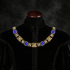 Frontal view of Ambrossio chain of foffice in brass finish with two strand of pearls and Blue cabochons on a black doublet mannequin